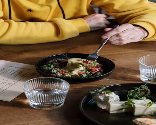 Close up of a healthy vegetable salad and a glass of water on a table